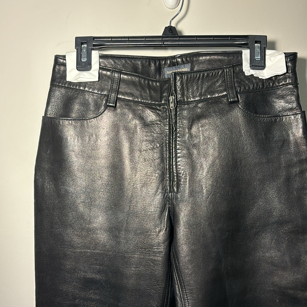 Banana Republic blk leather pants. Front zipper. Bttm left leg torn. 15" across